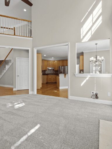 Open living room looking into kitchen and staircase